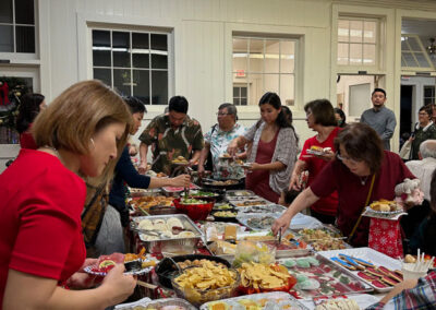 People serving christmas dinner to their own plate at Makiki Christian Church Christmas eve 2024