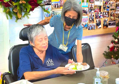 Makiki-christian-church lady serving plate lunchto senior lady